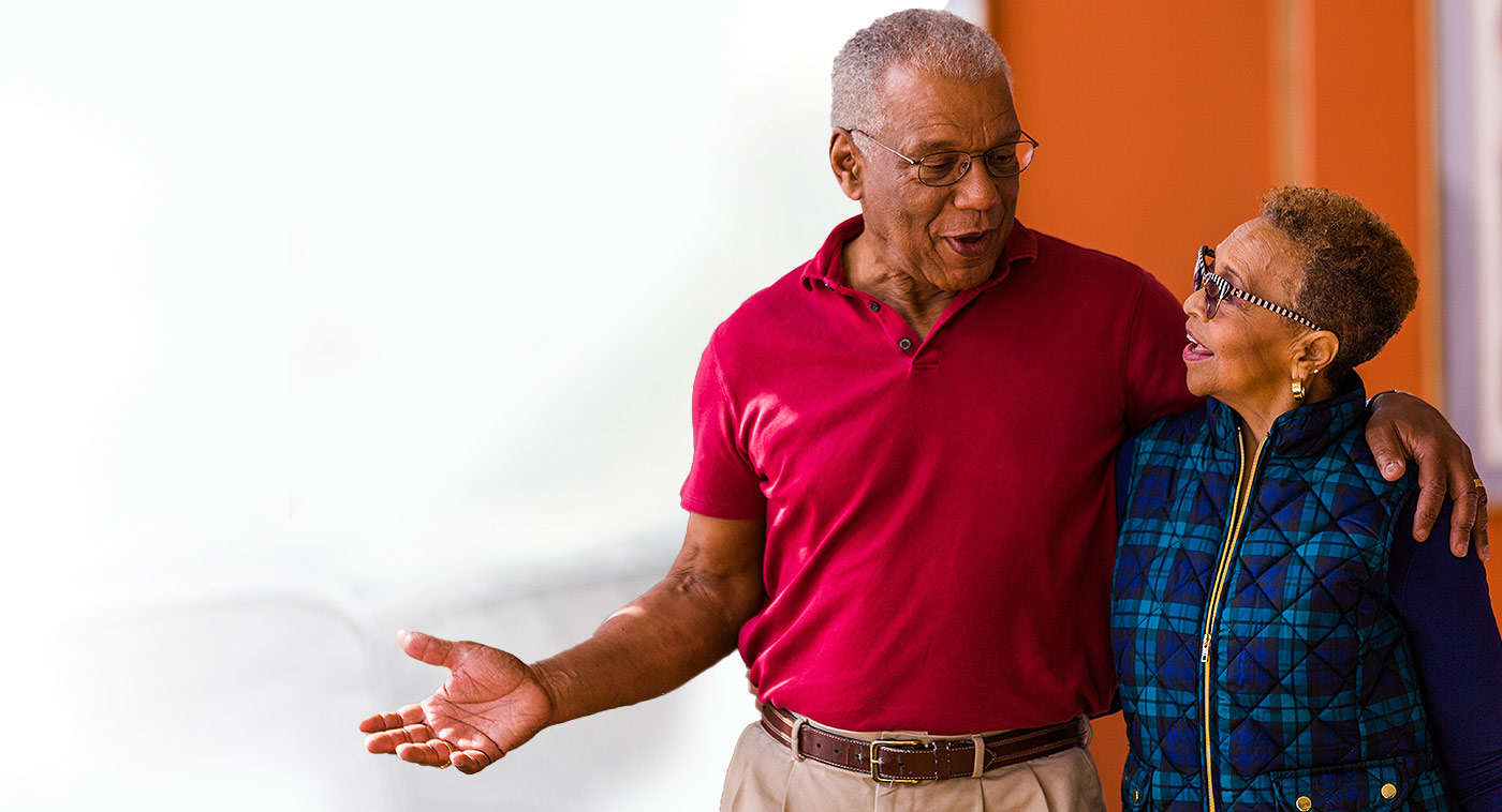 senior couple talking to each other on a walk